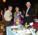Bob Spotts is describing the significance of the Mesa Verde bloom in the wine glass with two guests