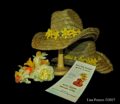Cowboy hats with daffodils, flowers and the Save the Date! flyer